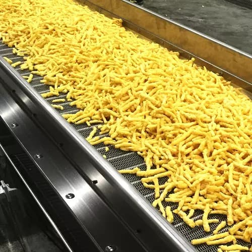 Extruded corn snack production